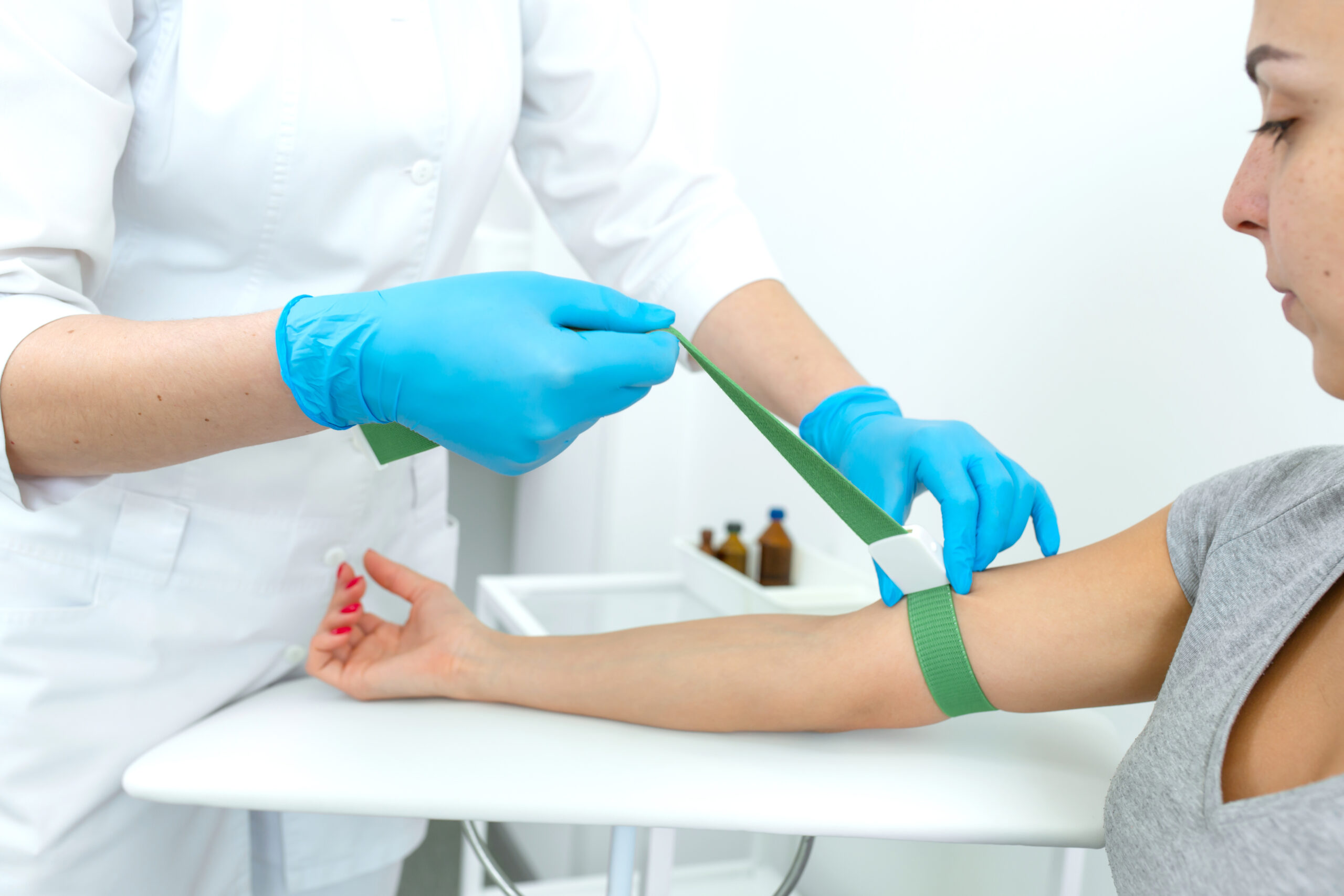 the nurse fastens the clip on the patients hand before the blood sampling procedure.